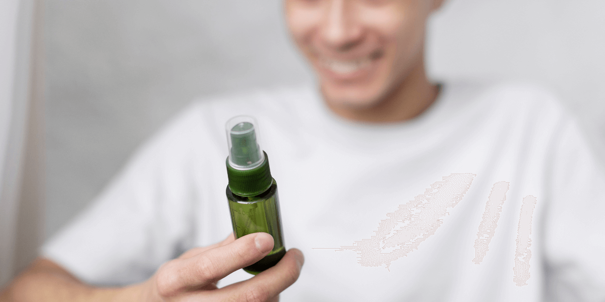 A man holding a delay spray bottle in his hand.